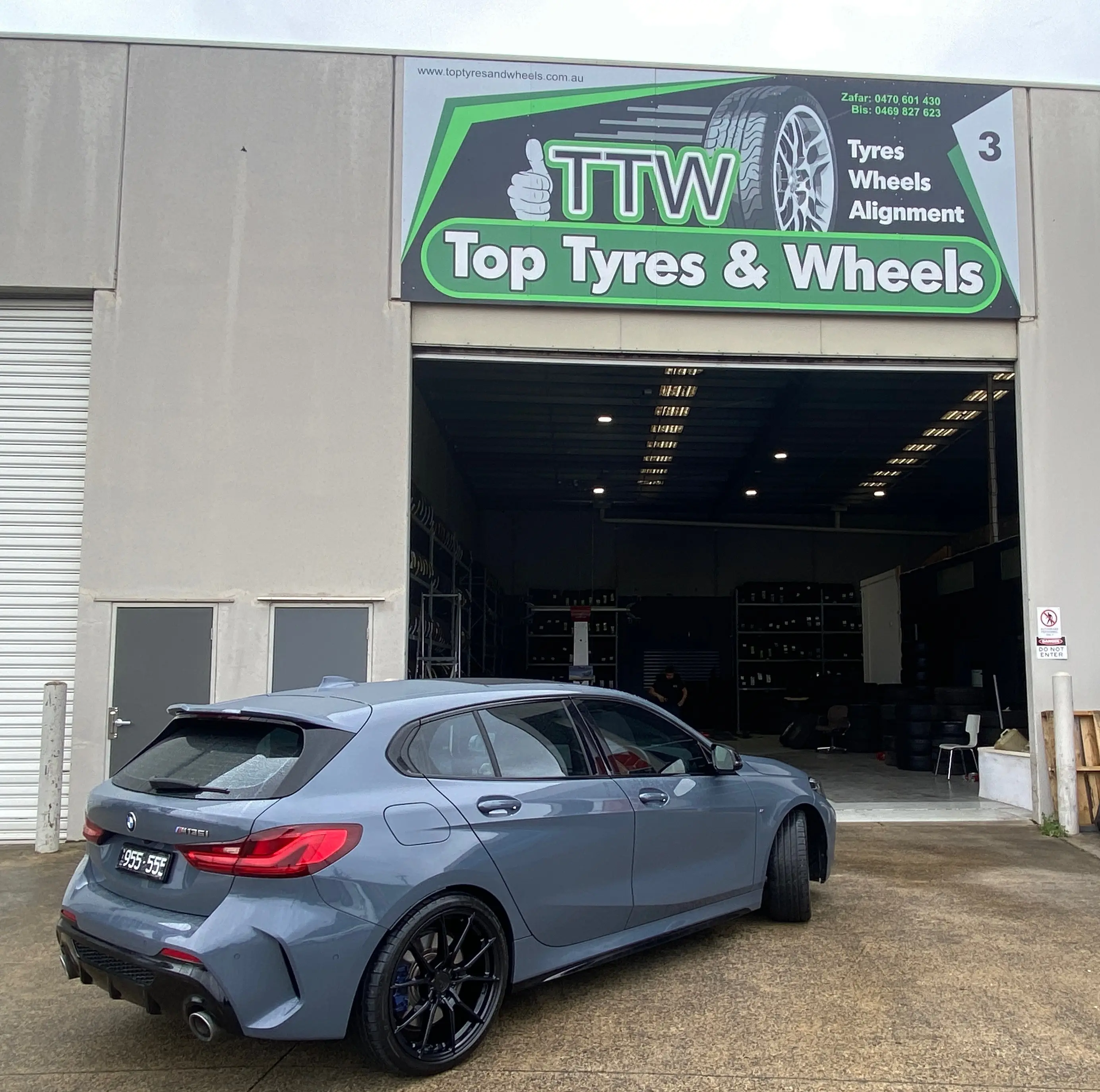 Grey hatchback after a wheel fitment at the workshop